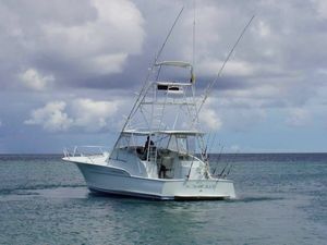 Buddy Davis 52 Express 1997 Buddy Davis 52 Express boat on calm ocean under cloudy sky.