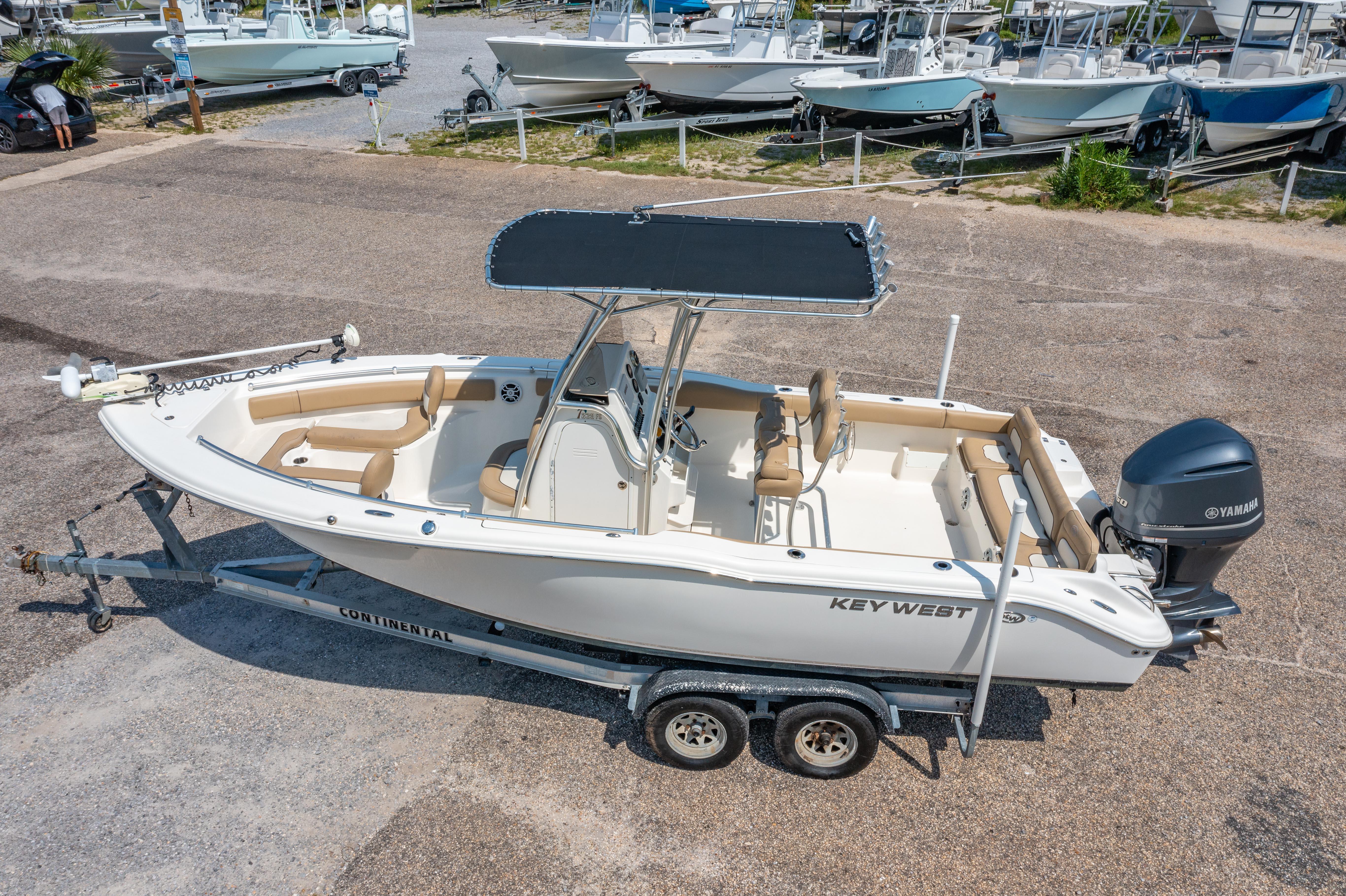 Key West 239 FS 2017 Key West 239 FS boat on trailer, parked in a marina with other boats.