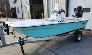Mako Pro Skiff 13 CC 2025 Mako Pro Skiff 13 CC boat on trailer, parked outside a garage.