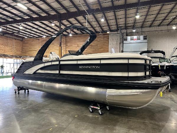 Bennington 23 RFBA 2024 Bennington 23 RFBA pontoon boat in a showroom setting.
