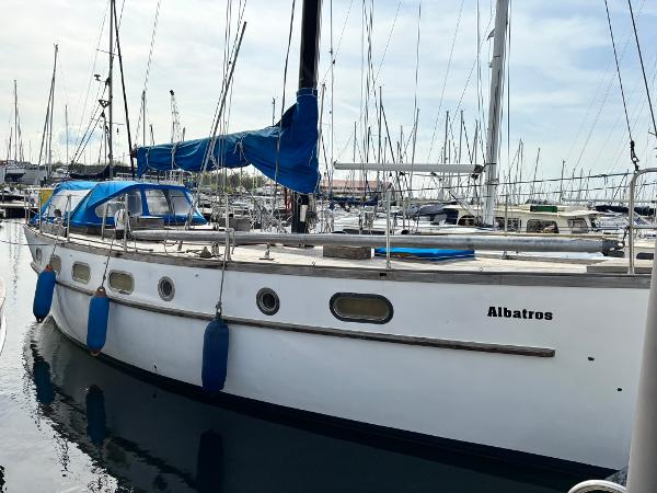Hartley Golden Cowrie 37 1983 Hartley Golden Cowrie 37 sailboat docked in marina, blue canopy, named "Albatros".