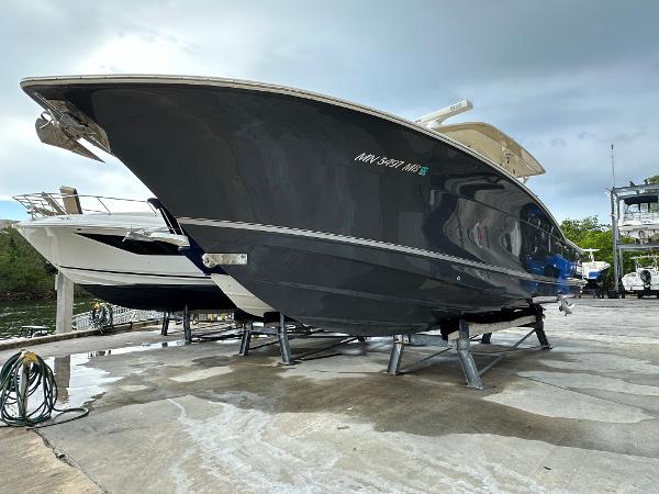 Scout 350 LXF 2017 Scout 350 LXF boat on dry dock, sleek design, ready for water adventures.
