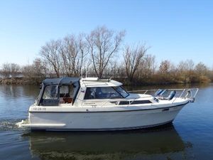Nimbus 3100T 1986 Nimbus 3100T boat cruising on a calm river with trees in the background.