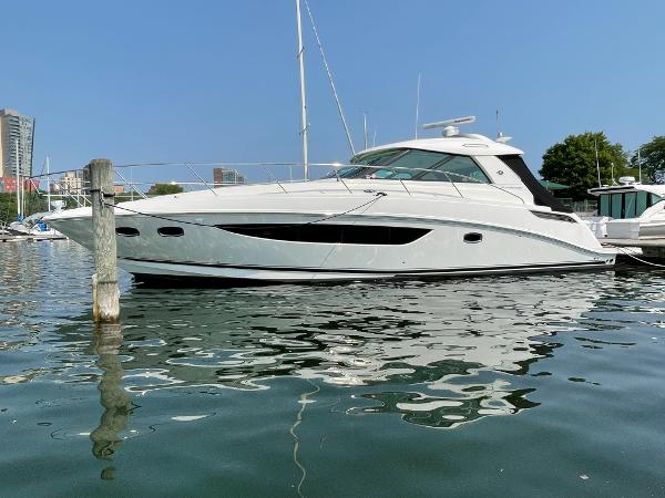 Sea Ray 450 Sundancer 2013 Sea Ray 450 Sundancer yacht docked in a marina on a sunny day.