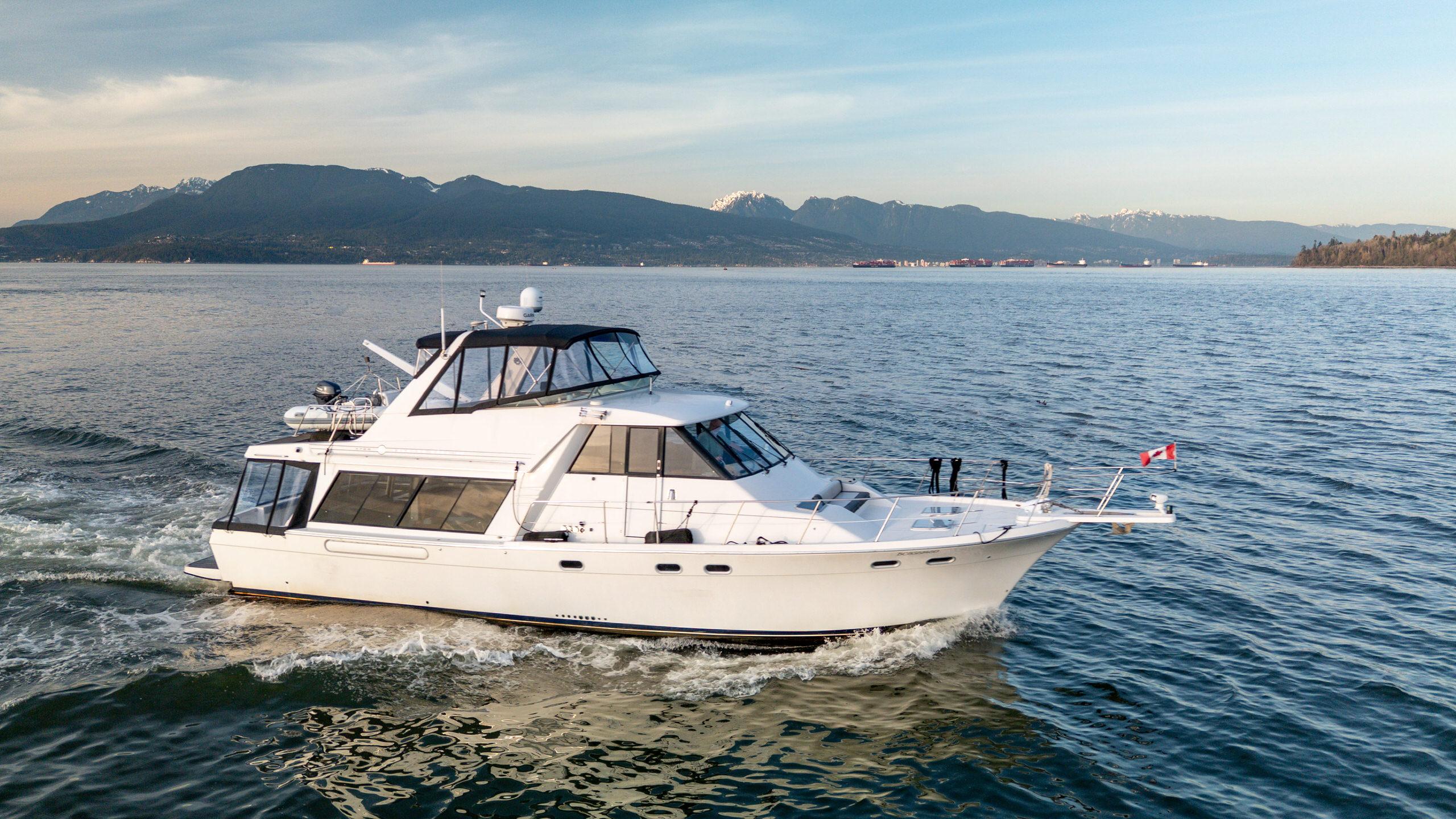 Bayliner 4788 Pilot House Motoryacht 1998 Bayliner 4788 Pilot House Motoryacht cruising on scenic waters with mountains in the background.