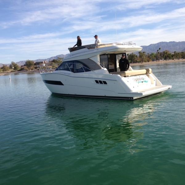 Carver C34 Command Bridge 2016 Carver C34 Command Bridge yacht on calm water with people onboard.