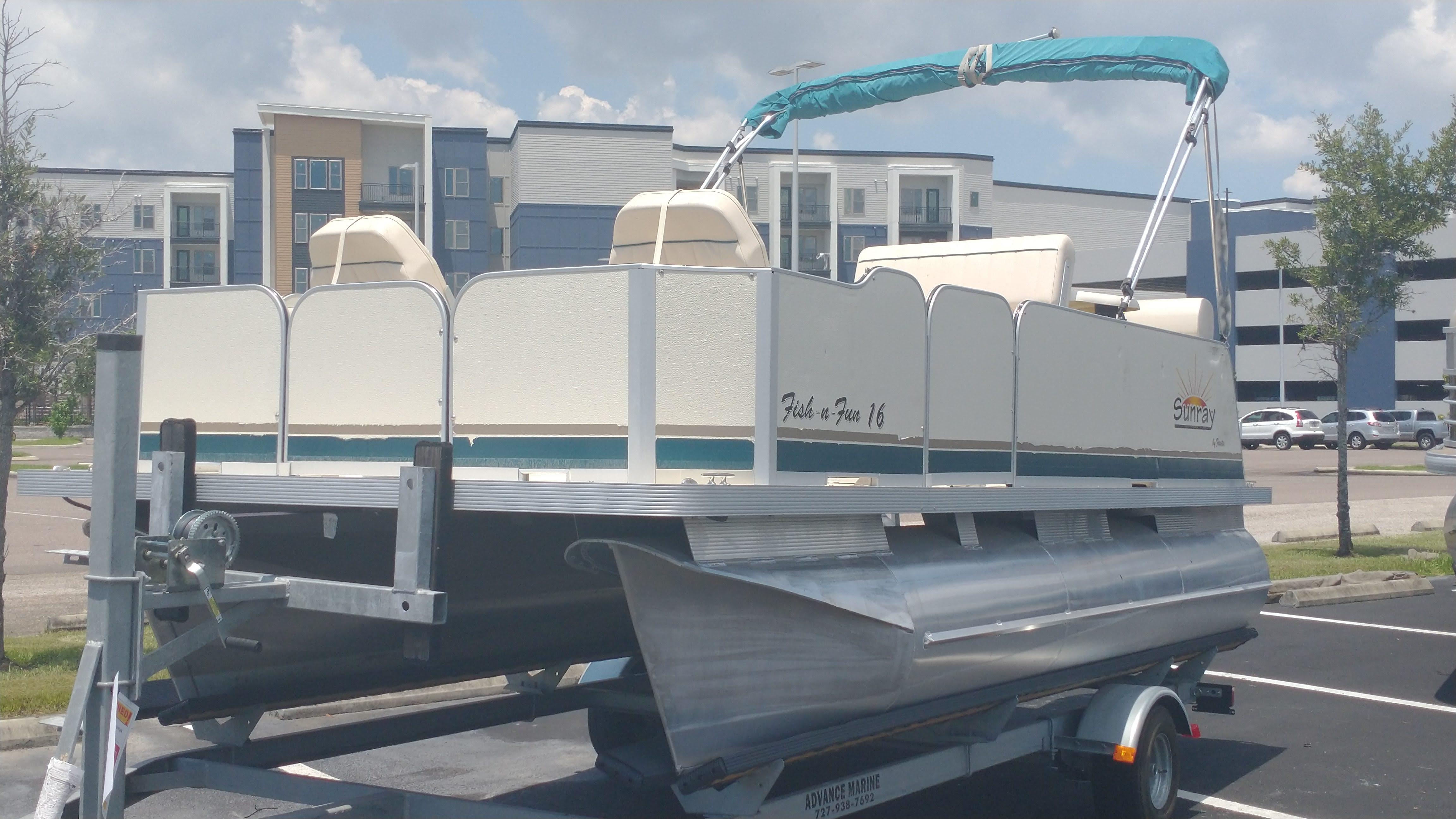 Sunray 16' Fish-n-Fun 2021 Sunray 16' Fish-n-Fun pontoon boat on trailer in parking lot.
