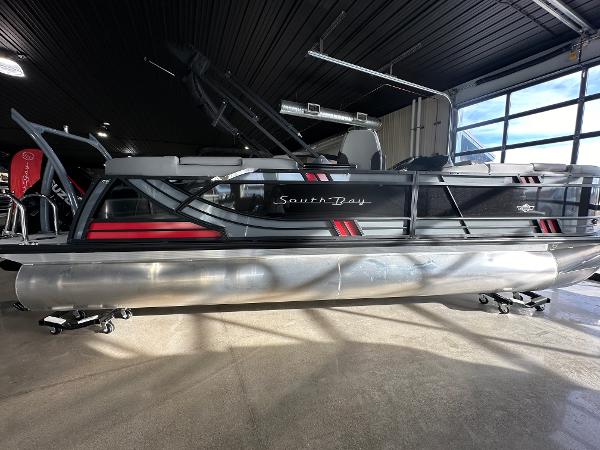 South Bay 523RS 2025 South Bay 523RS pontoon boat in showroom, featuring sleek design and modern accents.