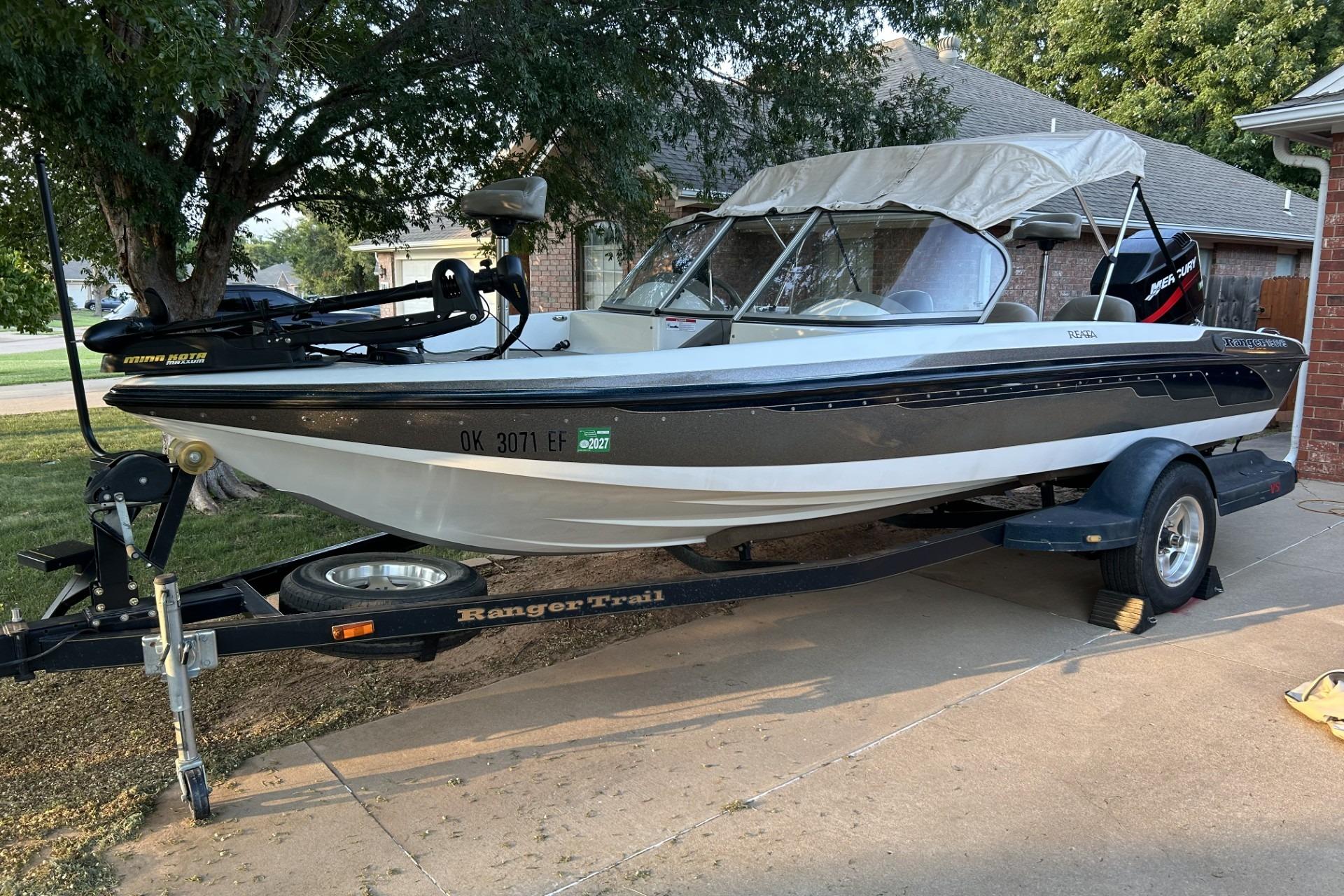 Ranger 190 VS 2004 Ranger 190 VS boat on trailer, parked in driveway, with canopy and motor.