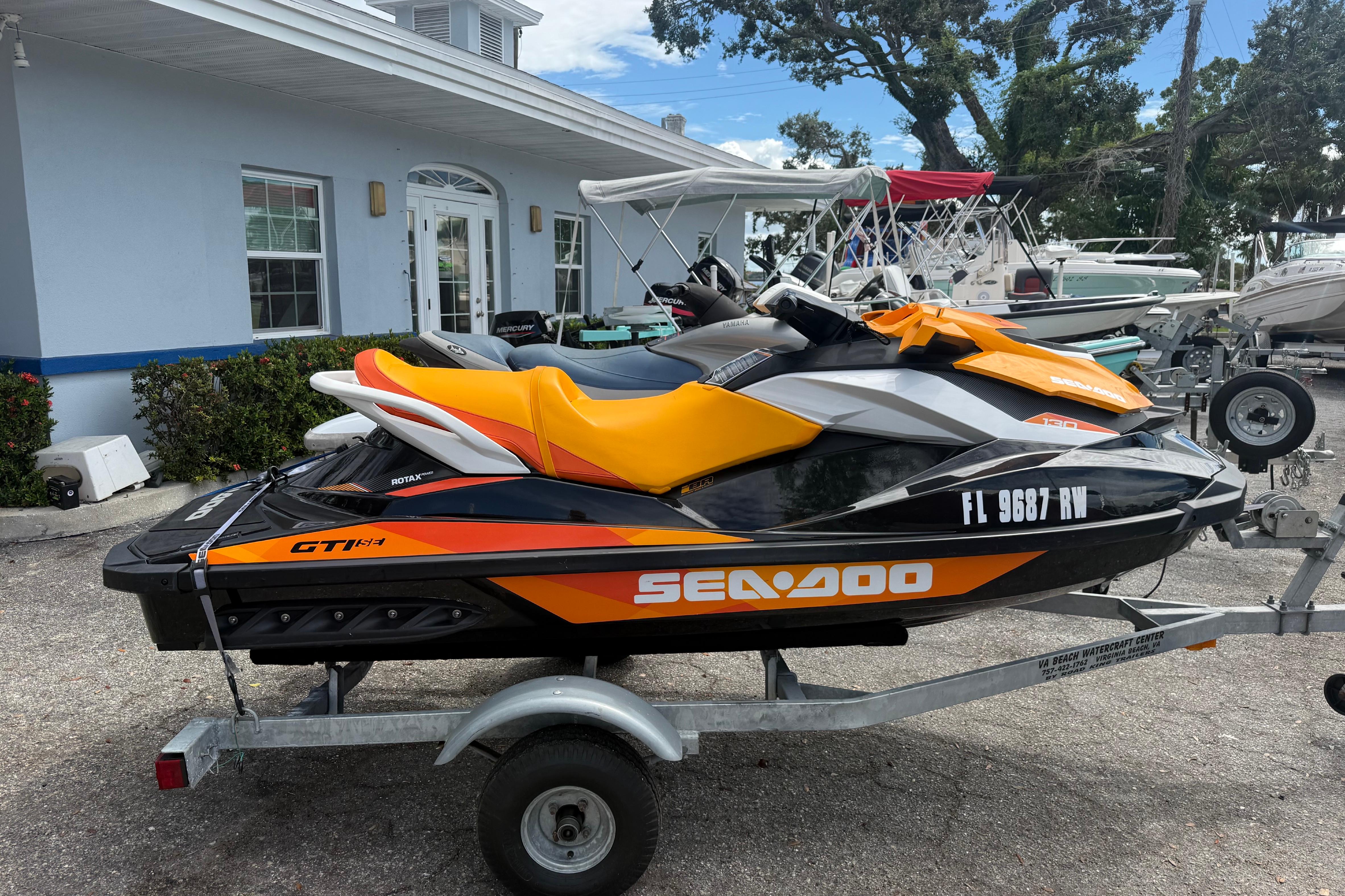 Sea-Doo GTI SE 130 2018 Sea-Doo GTI SE 130 jet ski on trailer, parked outside building.