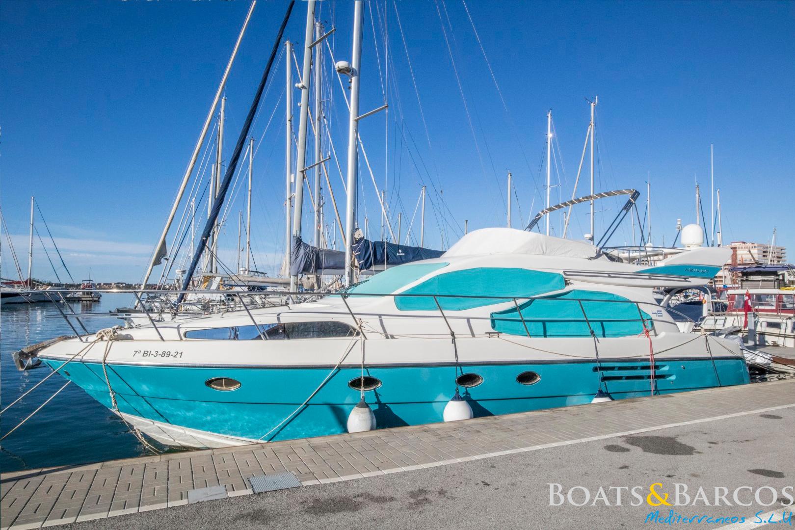 Azimut 46E 2007 Azimut 46E yacht docked at marina, featuring sleek design and vibrant blue accents.