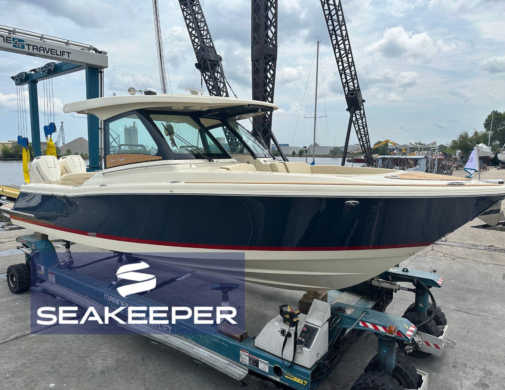 Chris-Craft Calypso 32 2025 Chris-Craft Calypso 32 boat on trailer at marina with Seakeeper logo.