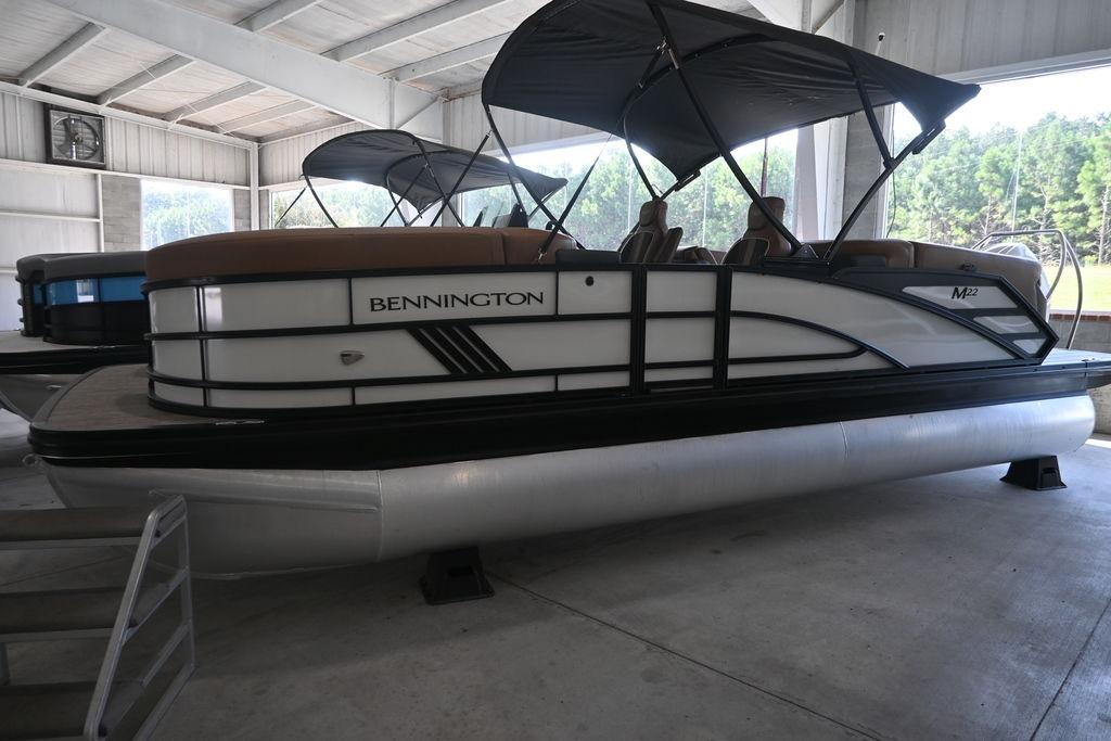 Bennington M Quad Bench 22 MFB 2025 Bennington M Quad Bench 22 MFB pontoon boat in a showroom.