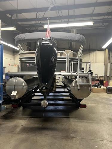 Sun Tracker Party Barge 20 DLX 2020 Sun Tracker PARTY BARGE® 20 DLX pontoon boat in a warehouse setting.