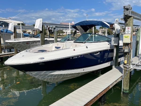 Chaparral 276 SSX 2009 Chaparral 276 SSX boat docked at a marina with blue canopy.