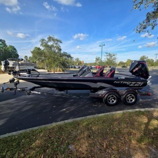 Nitro Z21 XL 2025 Nitro Z21 XL boat on trailer in parking lot, sunny day.