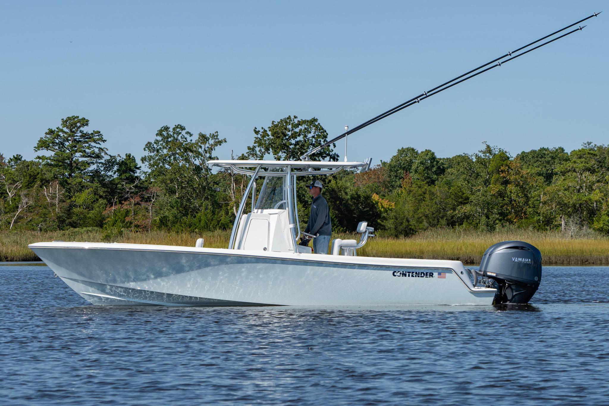 Contender 25T 2026 Contender 25T boat on water with Yamaha engine, surrounded by trees.