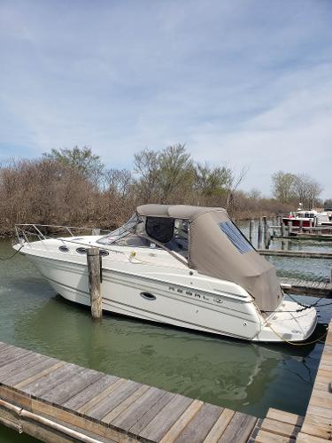 Regal Commodore 2660 2001 Regal Commodore 2660 boat docked in a serene marina setting.