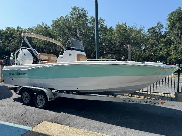NauticStar 211 Hybrid 2024 NauticStar 211 Hybrid boat on a trailer, side view.