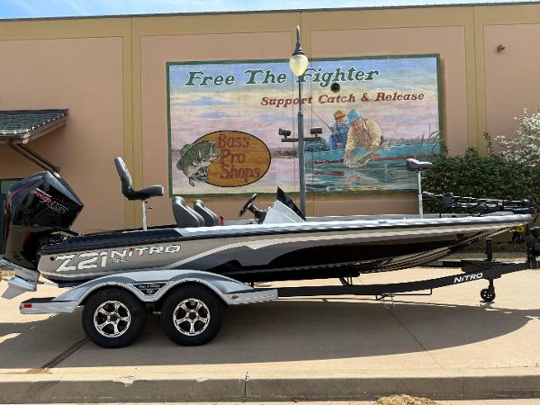 Nitro Z21 XL 2025 Nitro Z21 XL boat on trailer, parked near fishing-themed mural.