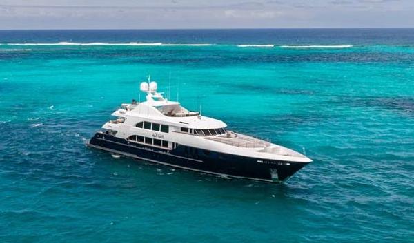 Trinity Yachts Tri-Deck Luxurious 2005 Trinity Yachts Tri-Deck cruising in vibrant turquoise waters.