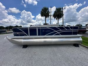 Sylvan Mirage Fish 820 Party Fish 4.0 2026 Sylvan Mirage Fish 820 Party Fish pontoon boat on display under cloudy sky.