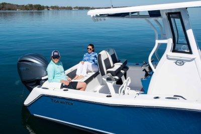 Tidewater 232 LXF 2026 Tidewater 232 LXF boat on calm water with two people relaxing onboard.