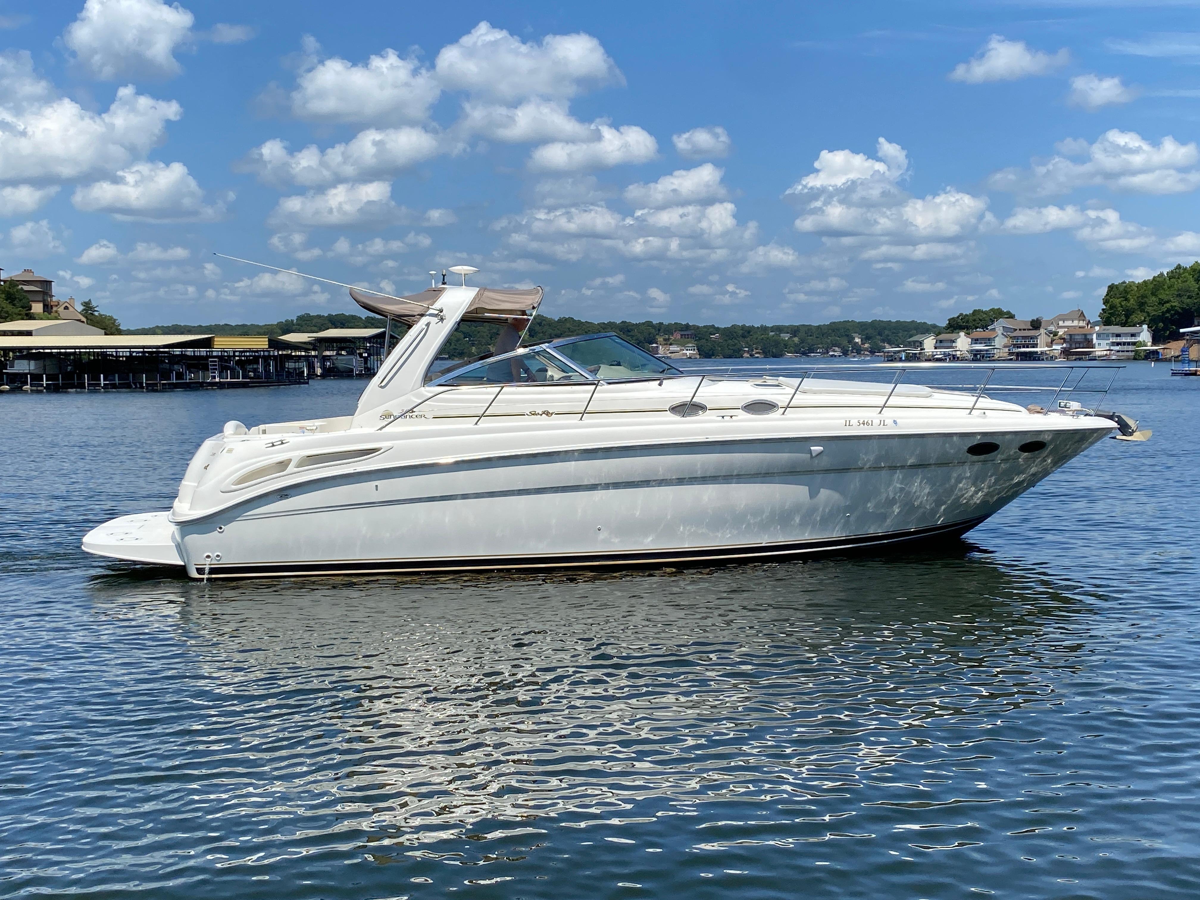 Sea Ray 380 Sundancer 1999 Sea Ray 380 Sundancer yacht on calm water under a blue sky with clouds.