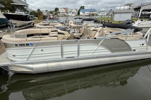 Berkshire 23RFX STS 2.75 2026 Berkshire 23RFX STS 2.75 pontoon boat docked, featuring beige seating and sleek design.