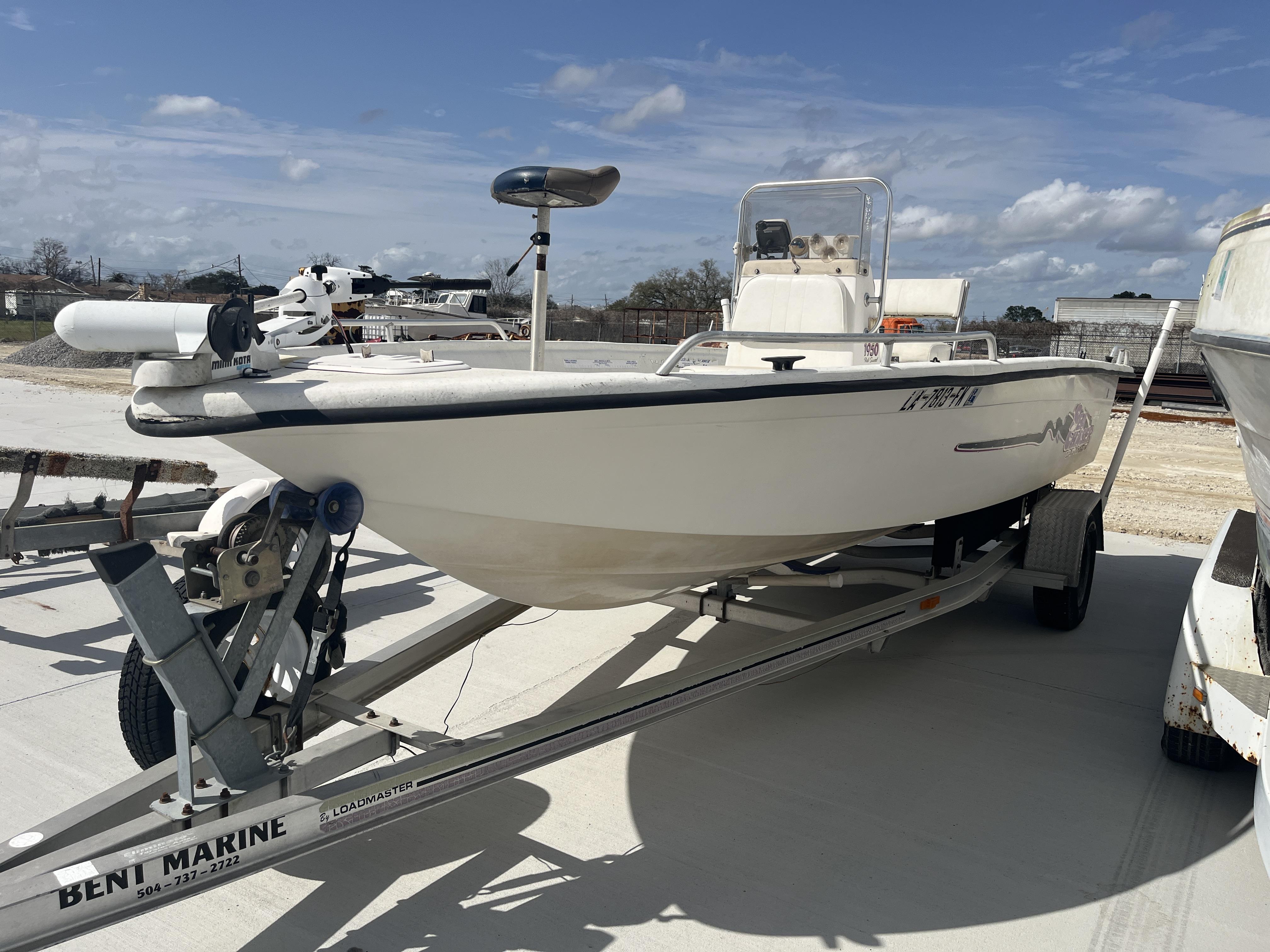 Sea Chaser 1950 Roll Gunnel 2004 Sea Chaser 1950 Roll Gunnel boat on trailer under clear sky.