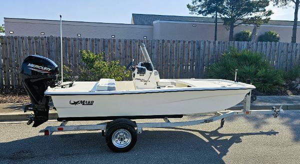 Mako Pro Skiff 13 CC 2025 Mako Pro Skiff 13 CC boat on trailer, parked outdoors.