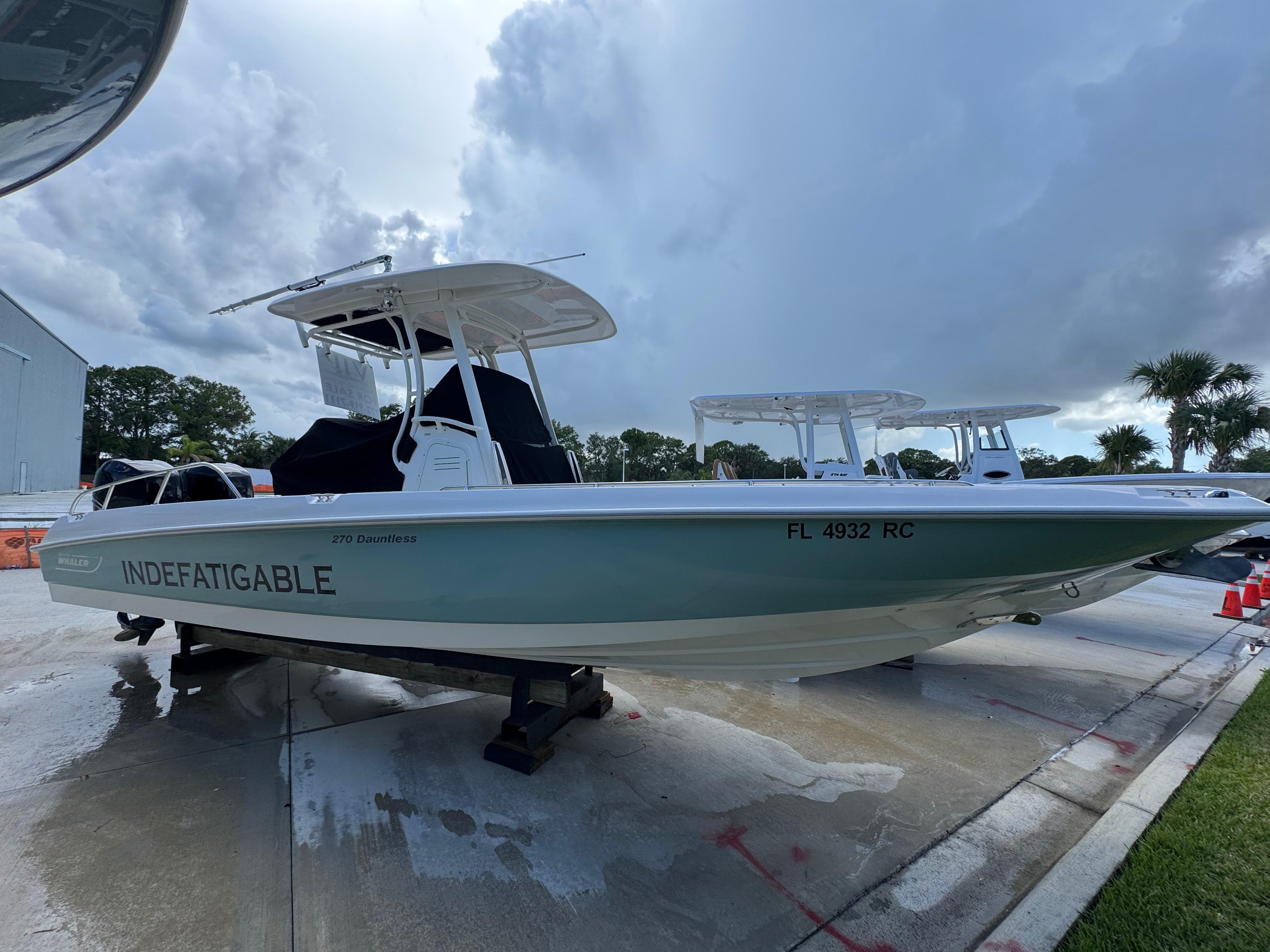 Boston Whaler 270 Dauntless 2016 Boston Whaler 270 Dauntless boat on display, named "Indefatigable," with overcast sky.
