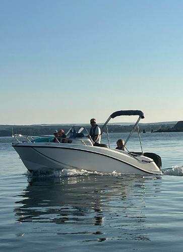 Quicksilver Activ 505 Open 2017 Quicksilver Activ 505 Open boat cruising on calm water with passengers.