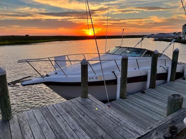 Crownline 250 CR 1997 Crownline 250 CR boat docked at sunset, serene waterfront view.