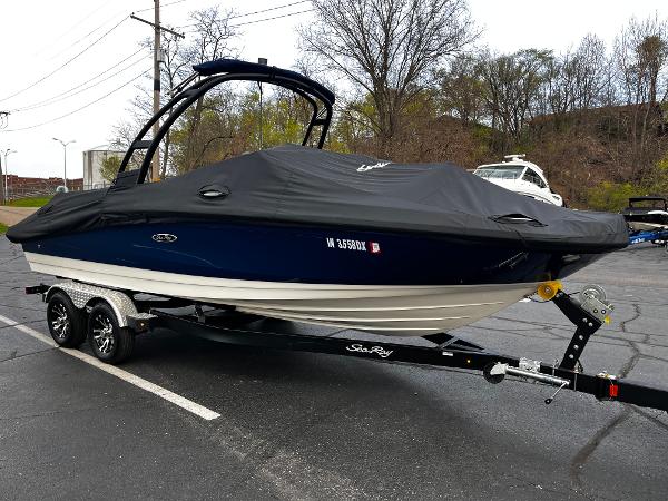 Sea Ray SPX 210 2022 Sea Ray SPX 210 boat on trailer, covered, parked in lot.