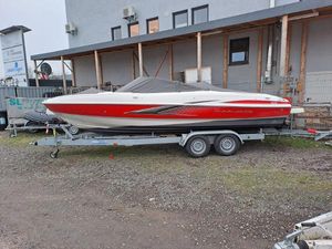 Maxum 2200 BOWRIDER, 5.0L MPI 2009 Maxum 2200 Bowrider boat on trailer, red and white design, parked outdoors.