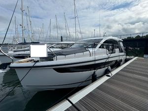 Sealine C335 2025 Sealine C335 yacht docked at marina, surrounded by sailboats under cloudy sky.