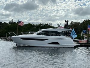 Bavaria R40 Coupe 2023 Bavaria R40 Coupe yacht docked, surrounded by flags, under a cloudy sky.