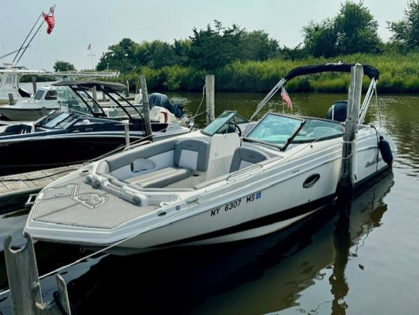 NauticStar 243 DC 2022 NauticStar 243 DC boat docked in a marina, featuring sleek design and comfortable seating.