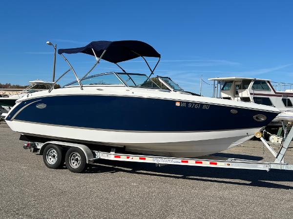 Cobalt R5 2014 Cobalt R5 boat on trailer with blue canopy in a marina setting.