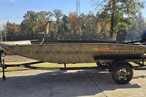 Tracker Grizzly 1756 T Marsh 2026 Tracker Grizzly 1756 T Marsh boat on trailer, camo design, parked outdoors.