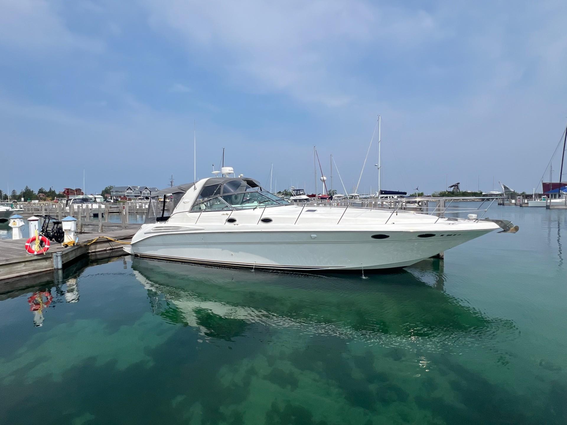 Sea Ray 400 Sundancer 1997 Sea Ray 400 Sundancer yacht docked in a marina under clear skies.