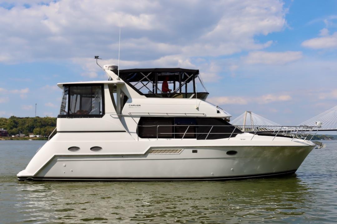 Carver 406 Motor Yacht 2001 Carver 406 Motor Yacht on calm water under a partly cloudy sky.