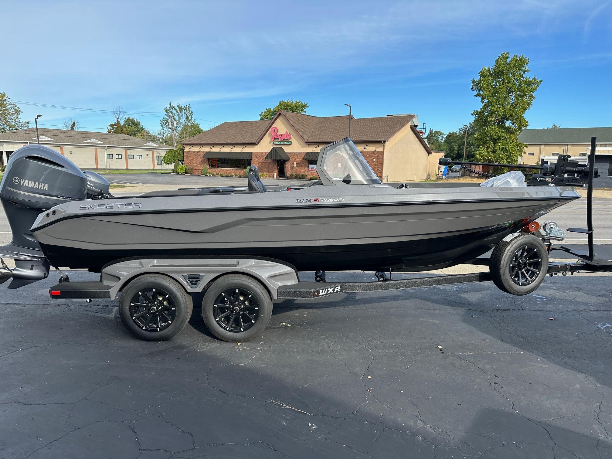 Skeeter WXR2060F 2025 Skeeter WXR2060F boat with Yamaha engine on a trailer in a parking lot.