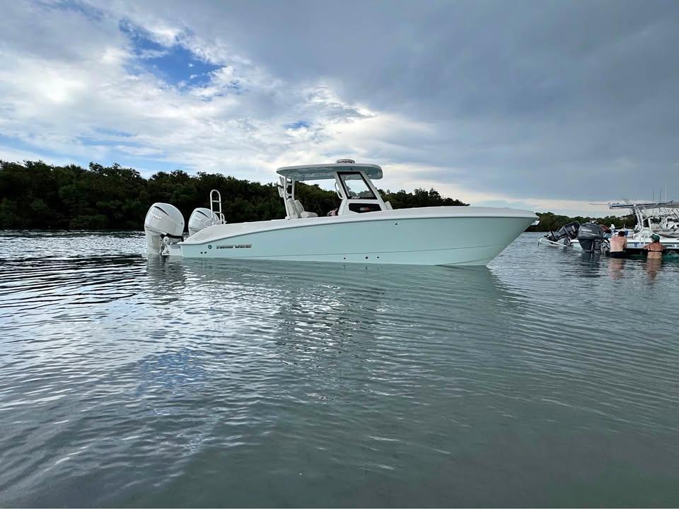 Twin Vee 280 GFX2 CC 2025 Twin Vee 280 GFX2 CC boat on calm water under cloudy sky.