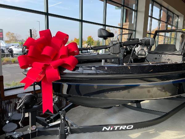 Nitro ZV21 2024 Nitro ZV21 boat with red bow on display in showroom.