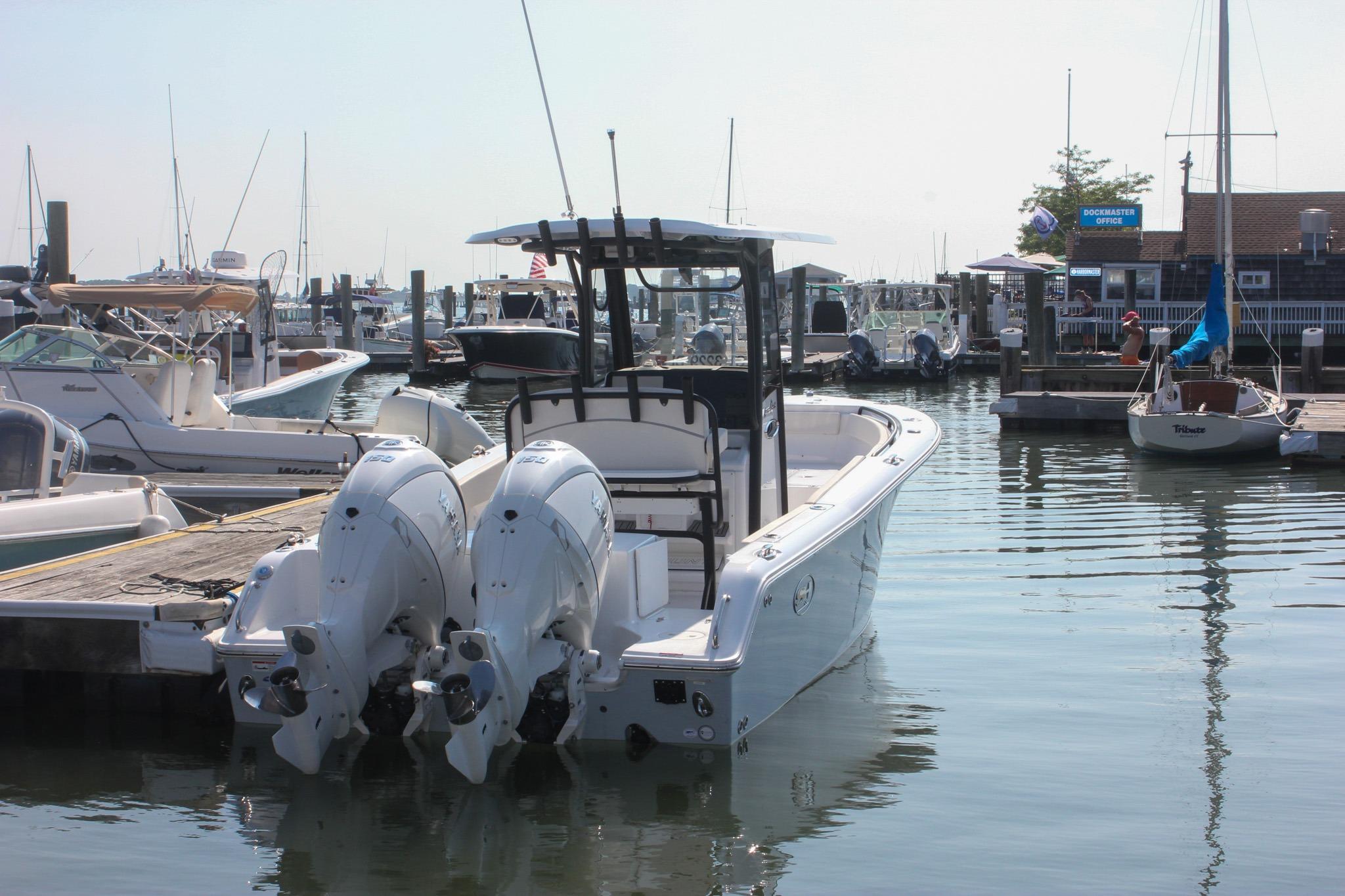 Sea Hunt Gamefish 25 2025 Sea Hunt Gamefish 25 boat docked at a marina with twin engines.