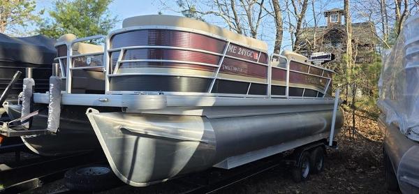 Godfrey 2286 FISH 2022 Godfrey 2286 FISH pontoon boat parked outdoors in wooded area.