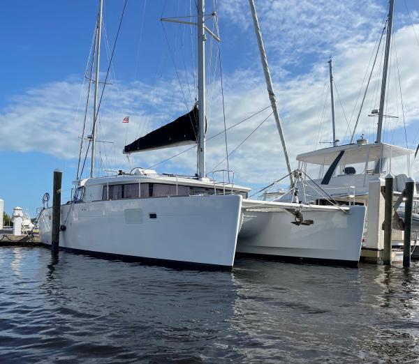 Lagoon 450 F 2018 Lagoon 450 F catamaran docked at marina under blue sky.