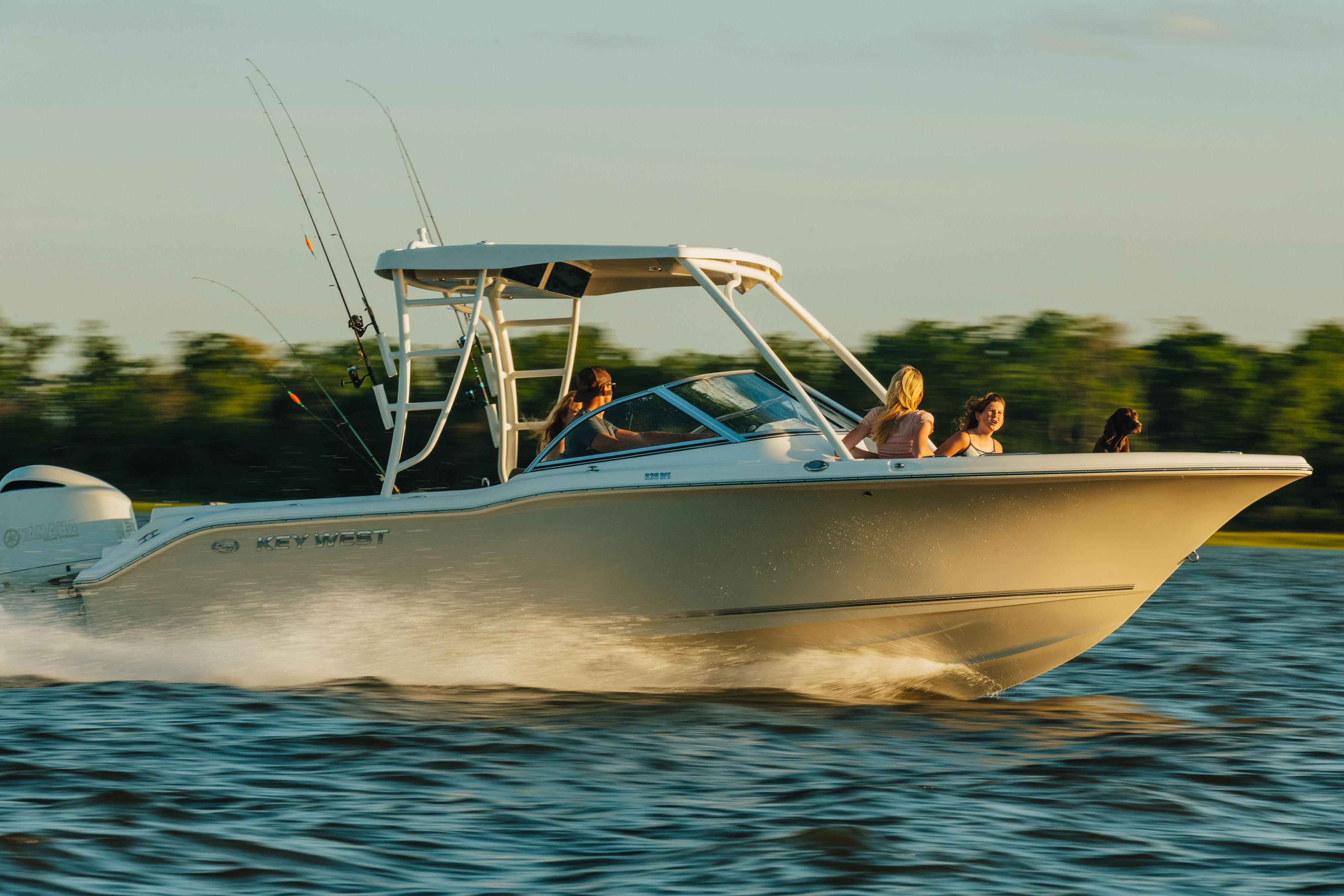 Key West 239 DFS 2025 Key West 239 DFS boat cruising on a sunny day with passengers.